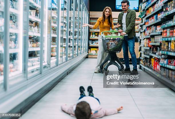 little toddler boy having a tantrum at the grocery store. - ilska bildbanksfoton och bilder