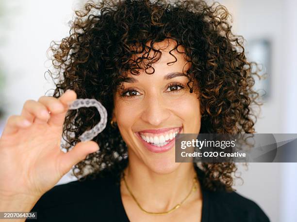 young woman with teeth aligner - aparelho dentário imagens e fotografias de stock