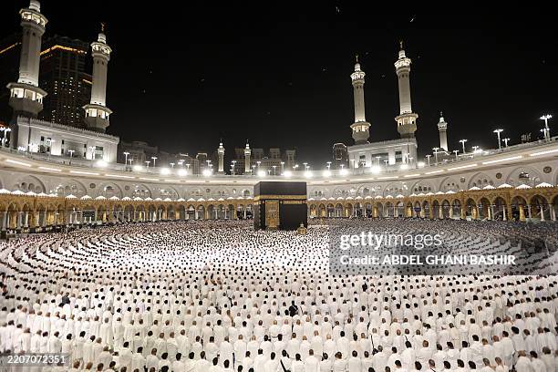 Muslims perform the morning prayer around the Kaaba at the Grand Mosque in Saudi Arabia's holy city of Mecca at the start of Eid al-Fitr, which marks...