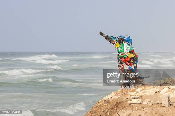 Senegalese environmental activist Modou Fall, also known as 'Plastic Man,' is raising awareness about environmental pollution with his costume made...