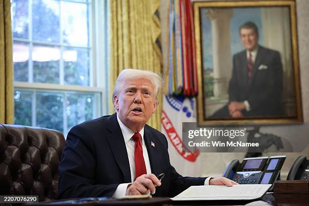 President Donald Trump speaks to the press before signing an executive order in the Oval Office of the White House on March 26, 2025 in Washington,...