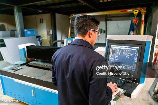 engineer programing a laser cutting machine at a metal factory - laser engraving stock pictures, royalty-free photos & images