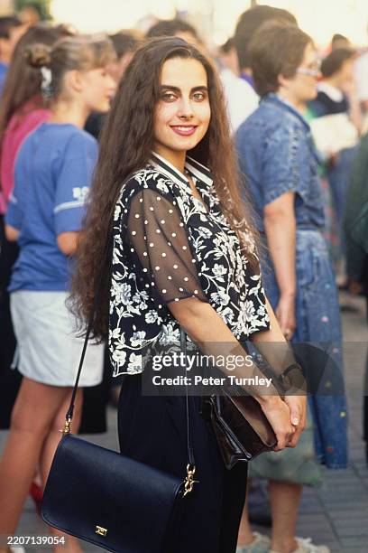 Woman with long brown hair standing on Arbat street in the centre of Moscow, Russia, July 29th 1991.