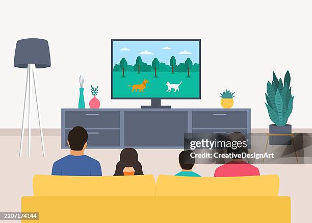 rear view of family sitting on sofa and watching cartoon movie. living room with television set, floor lamp and potted plant - happy children watching tv stock illustrations