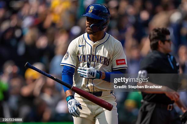 Julio Rodriguez of the Seattle Mariners flips his bat after hitting a two-run home run during the sixth inning of a game against the Athletics at...