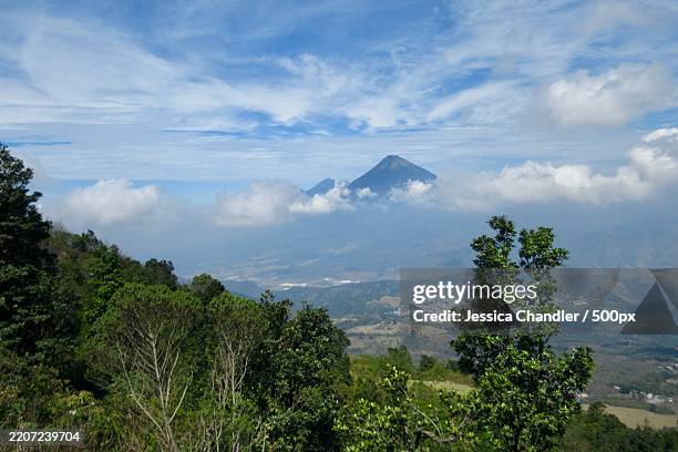 volcano in central america peeking through the clouds,guatemala - guatemala landscape stock pictures, royalty-free photos & images
