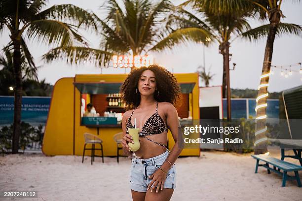 young black woman posing at a beach bar - leopard print stock pictures, royalty-free photos & images