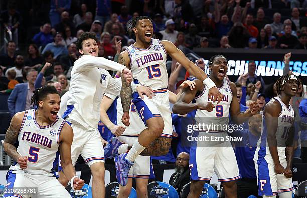Will Richard, Alijah Martin and Rueben Chinyelu of the Florida Gators celebrate with teammates on the bench against the Maryland Terrapins during the...