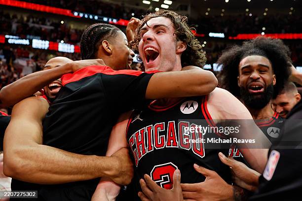 Josh Giddey of the Chicago Bulls celebrates with teammates after hitting a game-winning three pointer as time expired against the Los Angeles Lakers...