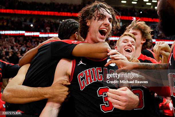 Josh Giddey of the Chicago Bulls celebrates with teammates after hitting a game-winning three pointer as time expired against the Los Angeles Lakers...