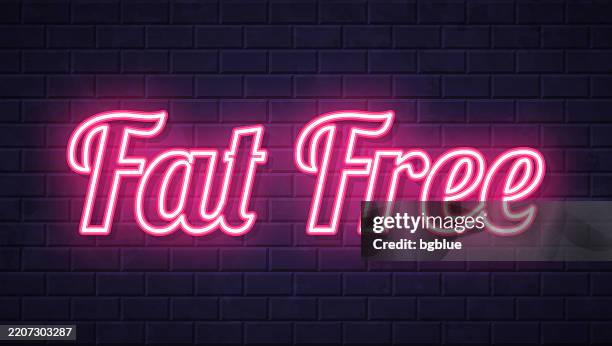 fat free - glowing neon text on brick wall background - purple brick background stock illustrations
