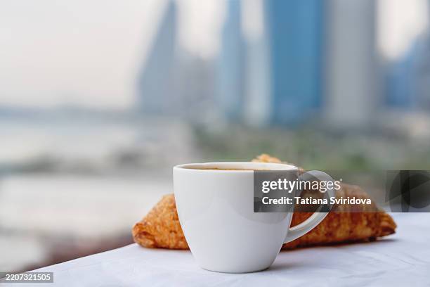 cup of coffee with croissant with doha of qatar cityscape line skyscrapers of west bank - embankment stock pictures, royalty-free photos & images
