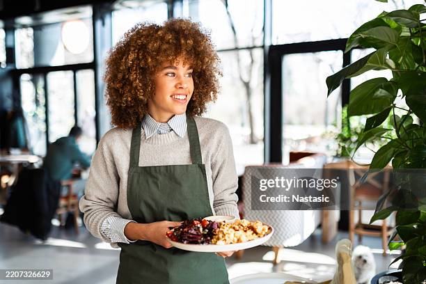 happy waitress delivering a meal - waiter stock pictures, royalty-free photos & images