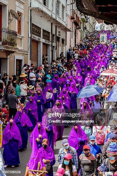 cucuruchos wearing purple robes and chains during the jesus del gran poder procession in quito - holy week stock pictures, royalty-free photos & images