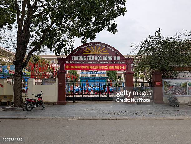 Students gather at Dong Tho Primary School in Thanh Hoa, Vietnam, on March 31 to raise the Vietnamese flag, which is hoisted every Monday morning to...