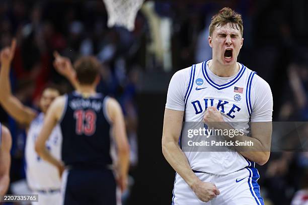 Cooper Flagg of the Duke Blue Devils reacts after scoring a three point basket to end the first half against the Arizona Wildcats in the East...
