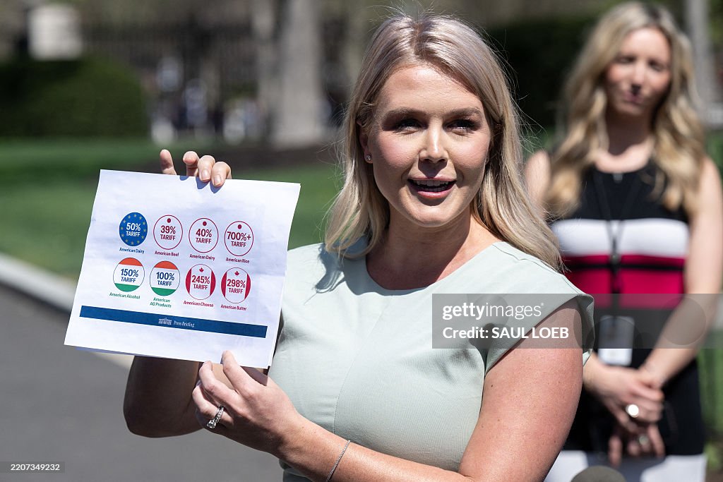 White House Press Secretary Karoline Leavitt holds up a chart showing