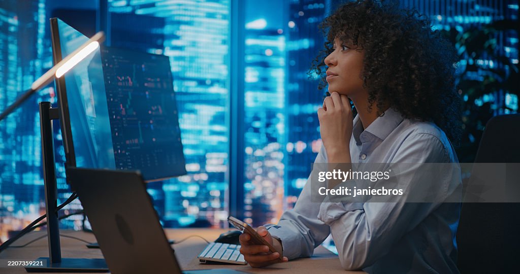 Female analyst writing a text message and waiting impatiently for information about market situation