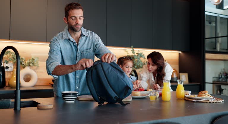 https://media.gettyimages.com/id/2207371676/video/family-child-and-morning-with-bag-for-school-breakfast-or-getting-ready-together-in-kitchen.jpg?b=1&s=640x640&k=20&c=uVbdARmr2gLkIrgO87QclJYFXI3-eTHY9pQQJZimNWg=