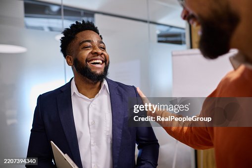 Manager congratulating a happy employee in the office Manager congratulating a happy employee in the office