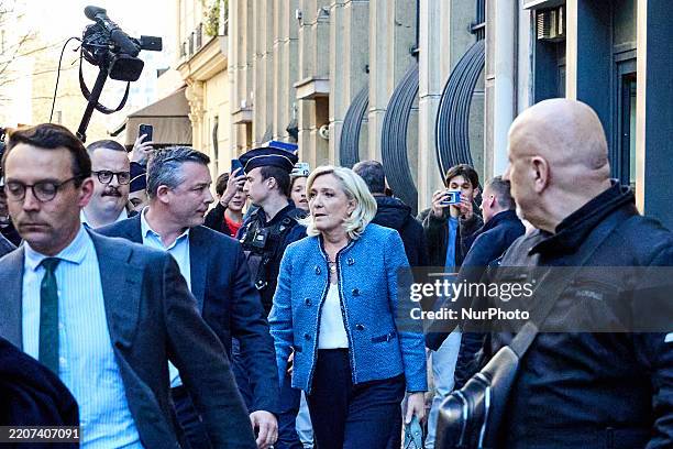 The president of the Rassemblement National RN parliamentary group Marine Le Pen leaves the Rassemblement National headquarters after a French court...