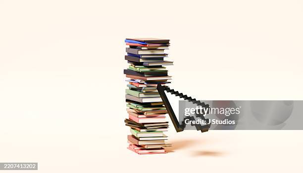 mouse cursor in front of large stack of books – learning and knowledge concept - virtual library stock pictures, royalty-free photos & images