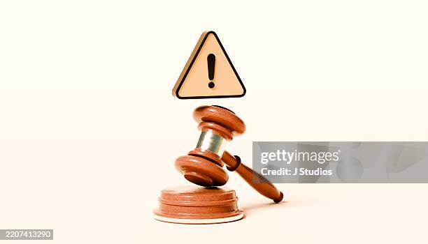 justice gavel with hovering yellow warning triangle – legal caution concept - construction mistake stock pictures, royalty-free photos & images