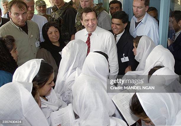 German Chancellor Gerhard Schroeder smiles at students of the Jamal Mina Girls school during a visit 09 May 2002 in Kabul. Schroeder is in Kabul for...