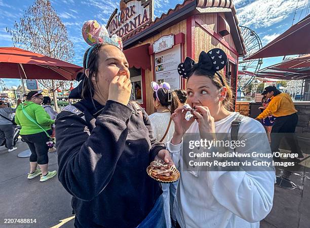 Anaheim, CA Sophia Pennison, left, and Christina Ybarra, try a chocolate Mickey-shaped macaron filled with caramel ganache made with SNICKERS bar...