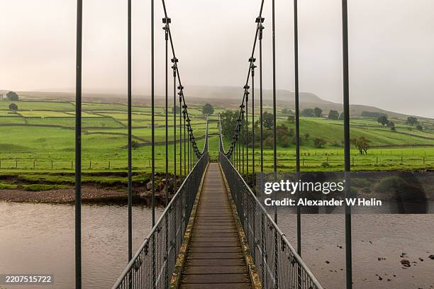footbridge over river swale - footbridge stock pictures, royalty-free photos & images