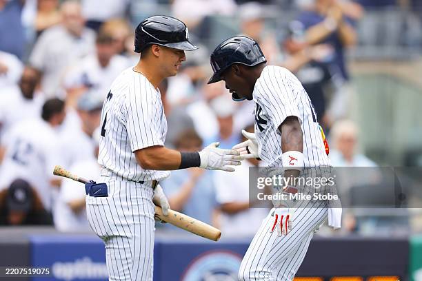 Jazz Chisholm Jr. #13 of the New York Yankees celebrates with Anthony Volpe after hitting a third inning home run against the Milwaukee Brewers at...