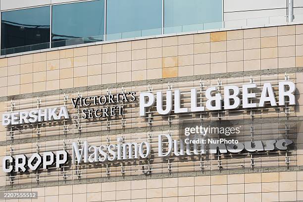 Logos of clothing stores Bershka, Victoria's Secret, Pull&Bear, Cropp, Massimo Dutti, and House are seen on the street in Warsaw, Poland, on March...