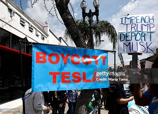 Protesters demonstrate against Tesla CEO Elon Musk’s Department of Government Efficiency initiatives during a nationwide “Tesla Takedown” rally...