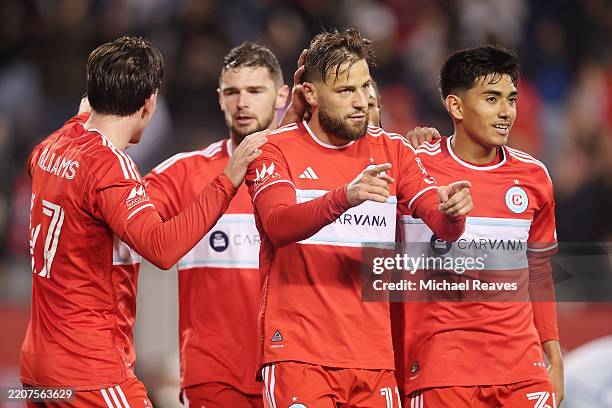 Philip Zinckernagel of Chicago Fire celebrates with teammates after scoring a goal against the CF Montreal during the first half at Soldier Field on...