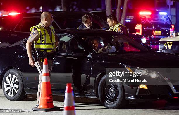 Florida Highway Patrol officers stop a driver at a DUI checkpoint at Meridian and 5th Street during spring break on Friday, March 15 in Miami Beach,...