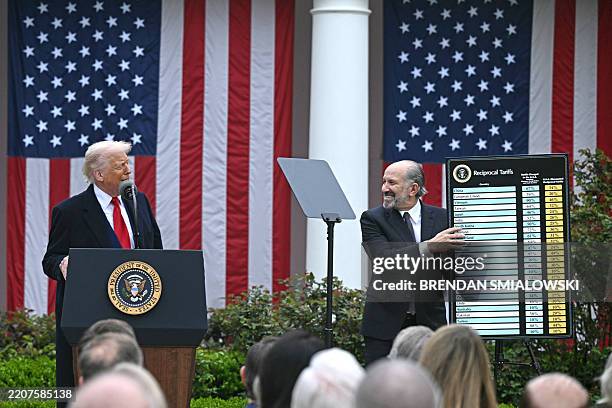 President Donald Trump delivers remarks on reciprocal tariffs as US Secretary of Commerce Howard Lutnick holds a chart during an event in the Rose...