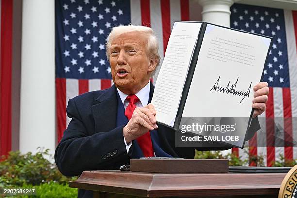 President Donald Trump holds a signed executive order after delivering remarks on reciprocal tariffs during an event in the Rose Garden entitled...