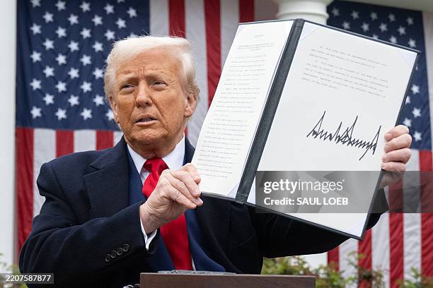 President Donald Trump holds a signed executive order after delivering remarks on reciprocal tariffs during an event in the Rose Garden entitled...