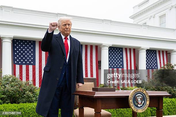 President Donald Trump pumps his fist after signing an executive order after delivering remarks on reciprocal tariffs during an event in the Rose...