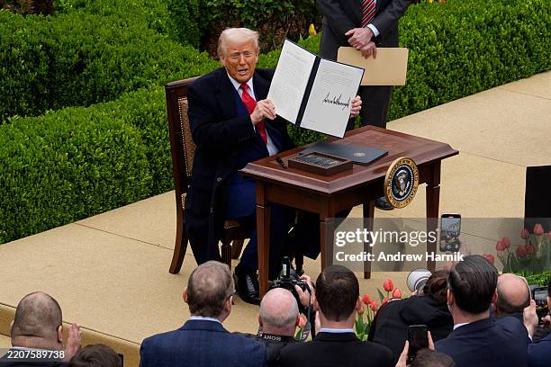 President Donald Trump signs an executive order imposing tariffs on imported goods during a "Make America Wealthy Again" trade announcement event in...