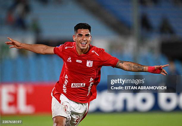 America de Cali's Peruvian forward Luis Ramos celebrates after scoring his team's third goal during the Copa Sudamericana group stage football match...
