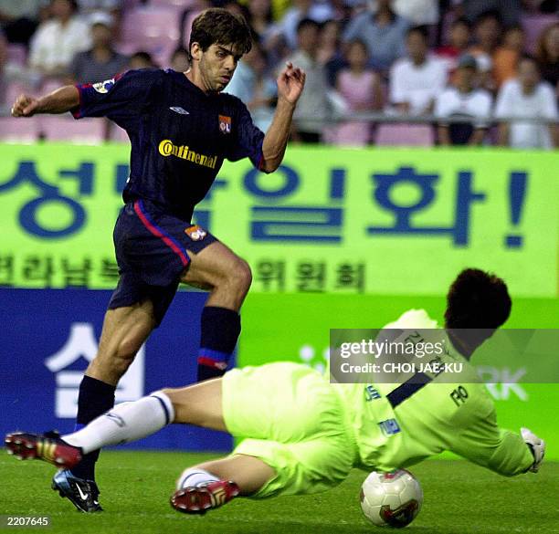 French soccer team Olympique Lyonnais player Juninho Pernambucano attempts a goal but is blocked by South Korea's Seongnam Ilhwa goalkeeper Kim...