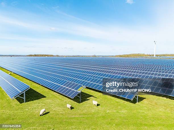 wind turbines and solar panels in england - solar power station stock pictures, royalty-free photos & images