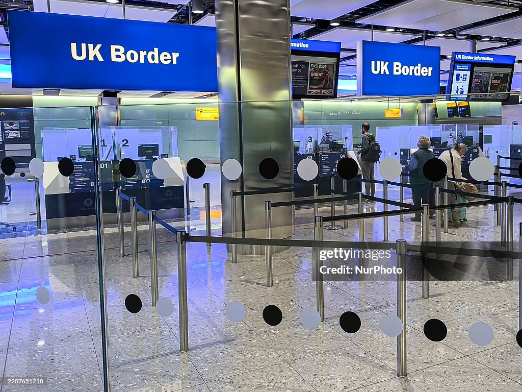 UK Border sign is seen at the arrivals passport control and visa area ...