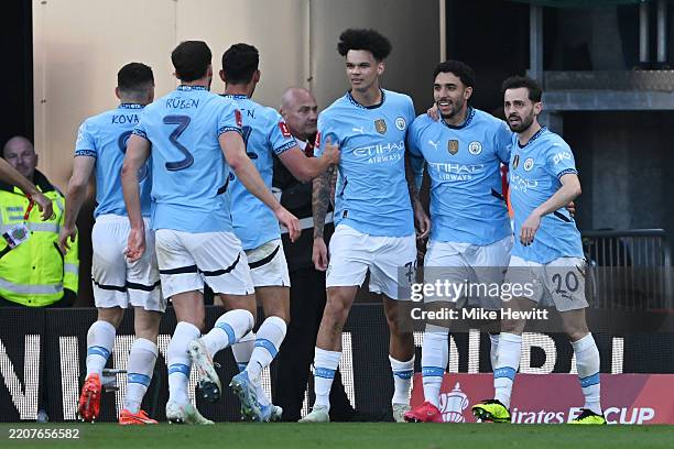 Omar Marmoush of Manchester City celebrates scoring his team's second goal with teammates Nico O'Reilly and Bernardo Silva during the Emirates FA Cup...