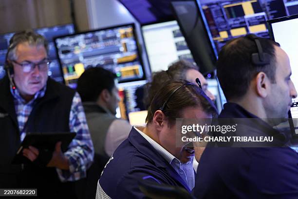 Traders work on the floor of the New York Stock Exchange at the opening bell in New York City, on April 3, 2025. Wall Street stocks sank in early...