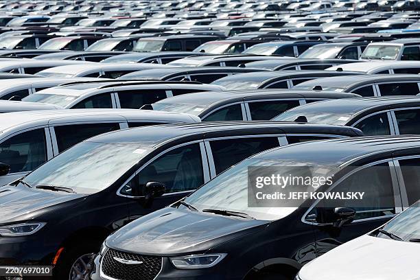 Chrysler Minivans that were assembled at the Stellantis Windsor Assembly Plant sit in a storage lot nearby in Windsor, Ontario, on April 3, 2025....