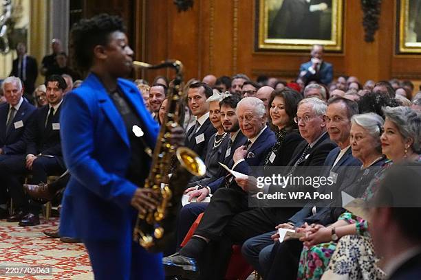 King Charles III and the audience watch a performance by YolanDa Brown in the Waterloo Chamber during a reception to recognise those involved in...