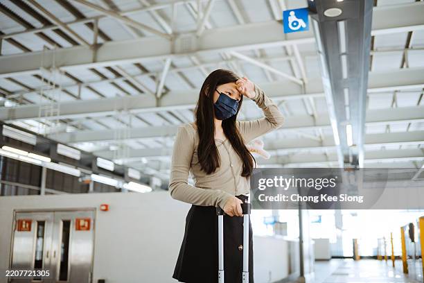 asian young woman with protective mask in public station. - herd immunity stock pictures, royalty-free photos & images