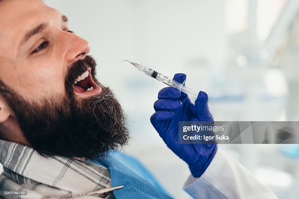 Dentist preparing anesthesia for a patient in the dental office